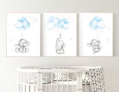 two baby pictures hanging on the wall above a crib with a teddy bear holding balloons