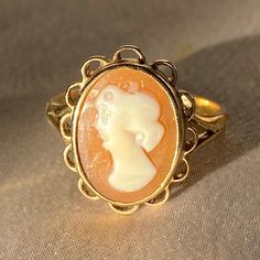 Vintage 9k yellow gold cameo ring with a detailed bezel set cameo of a woman's profile. The cameo's crown has a floral-like motif that is very common of its era, the 1970s. Great vintage condition Ring size: 7 Weight: 3.23 grams Hallmarks: 375 for 9k, anchor for Birmingham, 'Y' for 1973-74, maker's mark "W & G" A cameo is a miniature work of art. The most popular cameos today are carved in sea shells, a tradition that began in the fifteenth or sixteenth century and was popularized by Queen Victo Luxury Cameo Engagement Ring, Luxury Classic Cameo Ring, Luxury Vintage Cameo Ring, Victorian Revival, Female Profile, Romantic Jewellery, Love Token, Cameo Ring, Maker's Mark