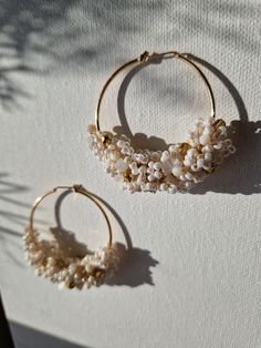 The stunning statement 'AMARA' earrings are crafted with inspiration drawn from the serene seaside and its golden beaches. These earrings are made with lustrous white Miyuki seed beads, natural white Jade chip beads, and Czech gold fire-polished crystal beads, hand-wired meticulously into waves and attached to 45mm gold plated hoops.  Due to hygienic reasons, I cannot accept refunds or exchanges for 'Amara' earrings as they are made to order. However, if you encounter any issues with your order, please do not hesitate to contact me, and I will gladly assist you. White 14k Gold Filled Hoop Earrings, White 14k Gold Filled Hoop Jewelry, Gold Beaded Hoop Earrings For The Beach, White Pearl Drop Hoop Earrings In 14k Gold, Handmade White 14k Gold Filled Hoop Earrings, Elegant White Hoop Earrings For Beach, Handmade 14k Gold Filled White Hoop Earrings, Wedding White 14k Gold Filled Hoop Earrings, White Beaded Hoop Earrings For Wedding