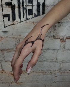 a woman's hand with a tattoo on it