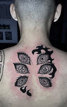 the back of a man's neck with an intricate tattoo design on his chest