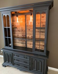 an old china cabinet with glass doors and drawers