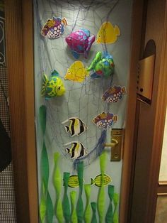 the door is decorated with colorful fish and seaweed, as well as other decorations