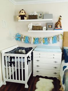 a baby's room is decorated in blue and white