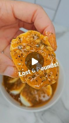 someone is holding an orange slice with the words lost and found on it in front of them