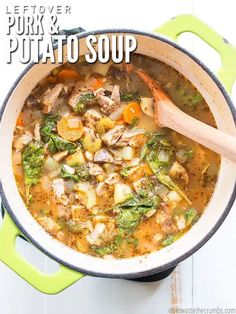 a pot filled with meat and vegetables on top of a white table next to a wooden spoon