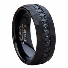 black ceramic wedding ring with black diamonds inlayed into the center and an inscription on it