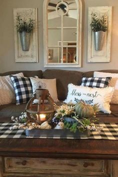 a living room filled with furniture and pillows on top of a coffee table in front of a mirror