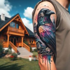 a man's arm with a colorful bird on it and watercolor paint splatters