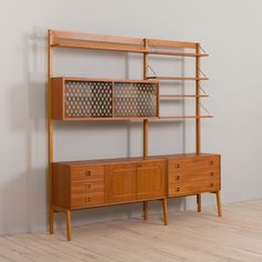 a wooden shelf with drawers and shelves on it