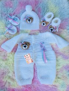 a teddy bear outfit and booties are laying on a blanket