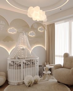 a baby's room with a crib, rocking chair and lights on the ceiling