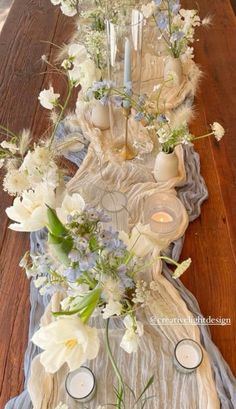 a long table with candles and flowers on it