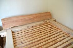 a bed frame made out of wooden planks