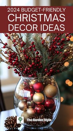 a glass vase filled with ornaments and pine cones