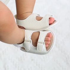 Step into Style and Comfort with Our Stylish Non-Slip PU Baby Sandals - Perfect for Newborns to 18 Months! Elevate Your Baby's Wardrobe with Fashionable Footwear Introducing our Stylish Non-Slip PU Baby Sandals, the perfect addition to your little one's summer wardrobe. Crafted with both style and safety in mind, these sandals offer a delightful combination of comfort and chic design. Key Features: PU Upper Material: The sandals feature a high-quality PU upper material, ensuring a soft and gentl White Adjustable Non-slip Sandals, White Sandals For Summer Playtime, Adjustable White Sandals For Playtime, Adjustable Non-slip White Sandals, White Sandals With Soft Sole For Spring, White Sandals With Soft Sole For Playtime, Cute Adjustable White Sandals, Summer Sandals With Soft Sole For Playtime, Crib Shoes Girl