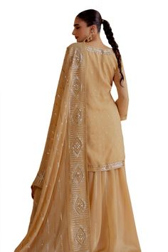 Gold, beige kurta with gota patti detailing on the neckline, sleeves and hem. Paired with a gherdar lehenga and embroidered dupatta. - Aza Fashions Beige Georgette Sharara With Zari Work, Beige Sharara With Zari Work For Navratri, Semi-stitched Beige Sharara With Zari Work, Semi-stitched Beige Lehenga, Beige Sharara With Dabka Work For Reception, Designer Beige Sharara With Gota Work, Beige Lehenga With Dabka Work, Festive Semi-stitched Beige Sharara, Festive Beige Semi-stitched Sharara