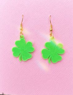 the earrings are green and have four leaf clovers on them