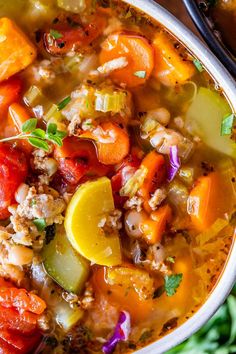 a white bowl filled with soup and vegetables