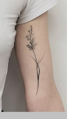 a woman's arm with a flower tattoo on the left side of her body