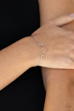 A dainty silver heart frame attaches to a dainty silver bangle-like cuff, creating a flirty centerpiece around the wrist. Features a toggle closure.

Sold as one individual bracelet. Bracelets Dainty, Paparazzi Jewelry Images, Live Text, Silver Heart Bracelet, Jewelry Watch, Rose Quartz Stone, Heart Frame, Paparazzi Accessories, Blue Gems