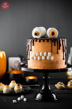 a halloween cake with googly eyes and marshmallows