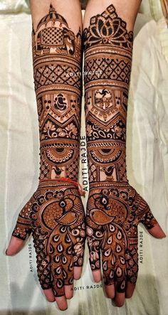 two hands with henna designs on them