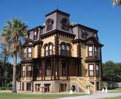 an old victorian style house with many windows and balconies on the second floor