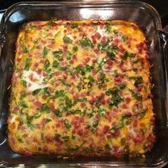 a square casserole with ham, cheese and spinach on it in a pan