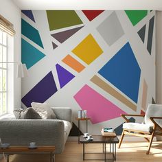 a living room filled with furniture next to a wall covered in multicolored squares