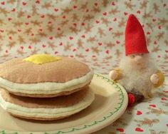 there is a plate with pancakes and a gnome on it