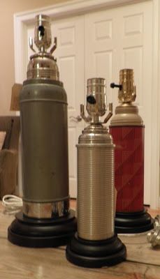 two old fashioned coffee grinders sitting on top of a table