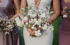 the bridesmaids are holding their bouquets in their hands