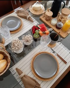 the table is set with plates, bowls and cups