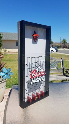 a game machine sitting on top of a cement bench