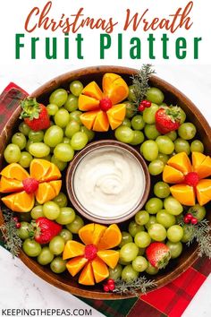 christmas wreath fruit platter with grapes, oranges and strawberries in the center