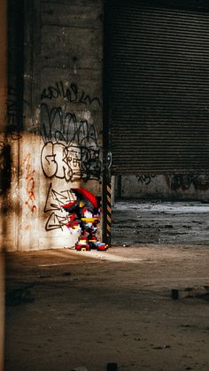 a building with graffiti on it and a red umbrella