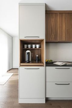 a kitchen with wooden cabinets and white appliances in the center, is shown on an appliance