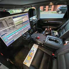 the inside of a vehicle with a computer and other electronics in it's center console