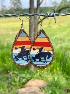 Cute Western Serape Teardrop Earrings Made with faux leather Featuring cowboy on bucking bronc horse Measuring 2.95 inches tall , 1.38 inches wide Made with alloy metals Bronc Horse, Bucking Horse, Gift Wrapping Services, Teardrop Earrings, Jewelry Earrings Dangle, Etsy Earrings, Dangle Drop Earrings, Cowboy, Dangle Earrings