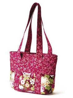 a pink bag with flowers on the front and bottom, sitting against a white background