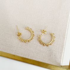 Limited Edition - Scallop Hoop Earrings. Please note this Limited Edition item is excluded from any holiday discount codes. Our Limited Edition items are already offered at a discounted prices and not eligible for any additional discounts. Dainty and unique, these small hoop earrings are great for everyday wear! Gold-plated hoop Gold-plated brass earring post Hoop measures approx. 3/4 inch in diameter Nickel-free Small Hoop Clip-on Earrings, Semi-circle Metal Hoop Earrings For Pierced Ears, Metal Semi-circle Hoop Earrings For Pierced Ears, Metal Semi-circle Hoop Earrings, Semi-circle Metal Hoop Earrings As Gift, Brass Earring, Small Hoop Earrings, Earring Post, Earrings Dainty