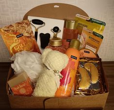 a box filled with lots of different types of beauty products and personal care items on top of a wooden table