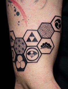 a man's arm with an abstract tattoo design on the back of his leg