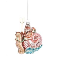 a glass ornament with a man on a sea horse holding a fishing rod