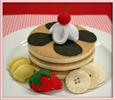 a plate topped with pancakes covered in frosting and toppings