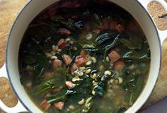 a pot filled with soup on top of a wooden table