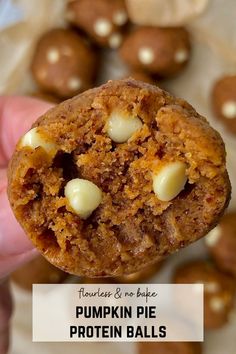 a hand holding a pumpkin pie protein ball