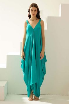 Turquoise modal asymmetrical maxi dress with a V neckline. - Aza Fashions Elegant Sleeveless Midi Dress In Turquoise, Elegant Sleeveless Turquoise Midi Dress, Elegant Turquoise Sleeveless Midi Dress, Chic Turquoise Maxi Dress For Summer, Sleeveless Turquoise Chic Midi Dress, Chic Sleeveless Turquoise Midi Dress, Elegant Turquoise V-neck Maxi Dress, Blue Draped Maxi Dress For Summer, Green Asymmetrical Maxi Dress For Vacation