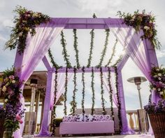 an outdoor seating area decorated with flowers and greenery for a wedding or reception venue